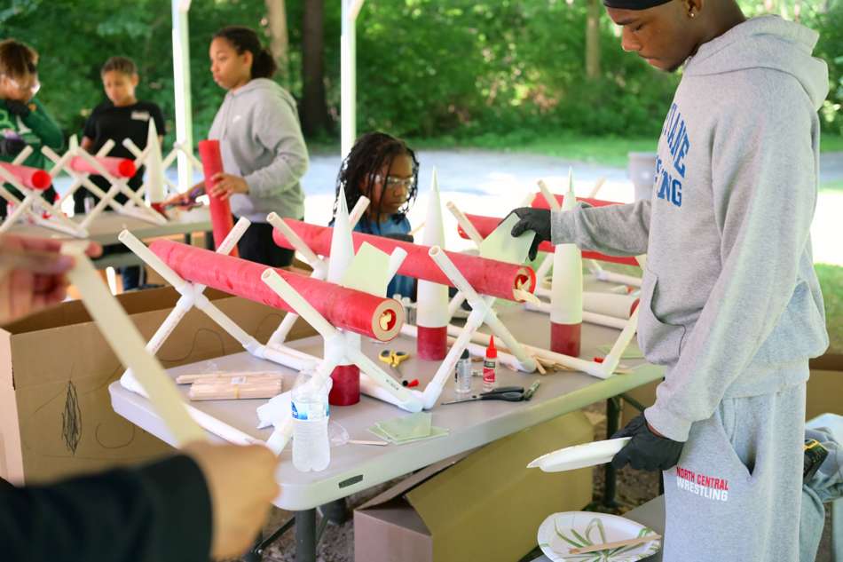 Students building rockets at the table